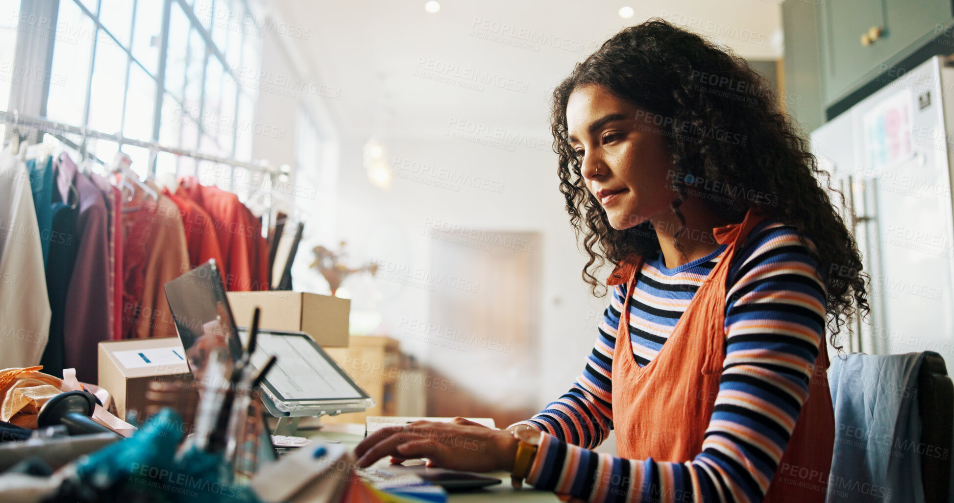 Buy stock photo Fashion, woman and typing on laptop at small business for inventory management, supply chain and dropshipping. Ecommerce, startup owner and tech for shipping info, delivery tracking or garment order