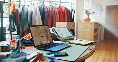 Buy stock photo Empty office, laptop and screen with fashion, clothes and rack on website with research for trends. Workshop, computer and tablet with sample garment, factory and planning for collection in studio