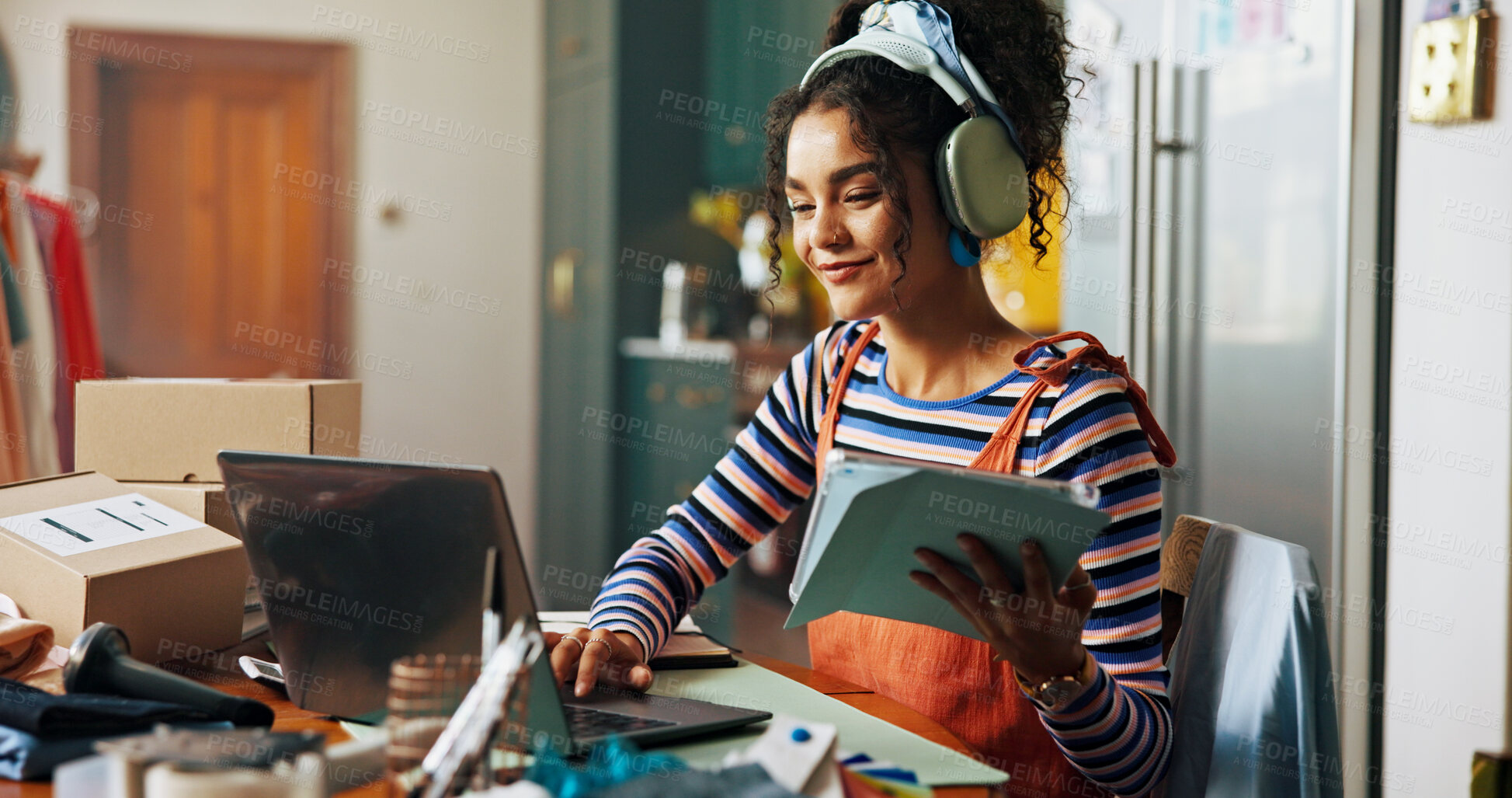 Buy stock photo Fashion designer, happy and woman on laptop and tablet for small business, ecommerce and supply chain. Creative, startup and person with music on headphones for tailor, textile and clothing retailer