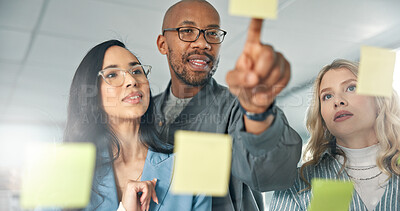 Buy stock photo Team, glass board and business people brainstorming, pointing at sticky notes with project ideas, schedule and agenda. Collaboration, problem solving and coworkers in planning meeting in workplace
