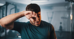 Tired, active and man with sweat at gym for fitness, intense exercise and recovery for workout. Male person, fatigue and burnout with physical training, endurance challenge and bodybuilding at centre