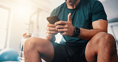 Buy stock photo Phone, hands and man on break in gym to chat on social media, fitness app or internet. Bodybuilding tips, research and athlete with mobile technology reading workout plan for training or exercise