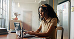 Girl, student and laptop with typing in home for online course, e learning and development in morning. Woman, person and editing project with pc for education, scholarship and class on web in kitchen
