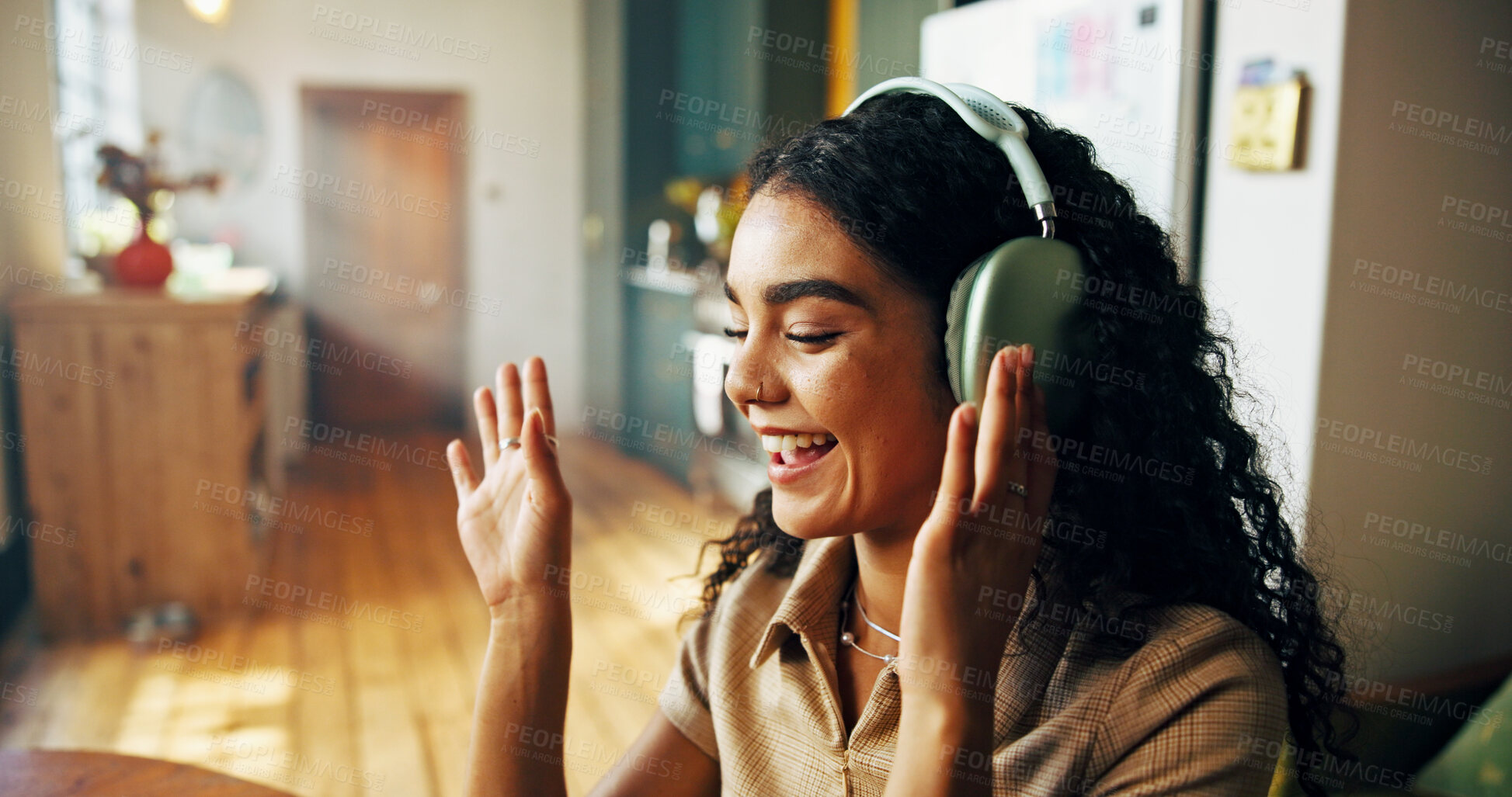 Buy stock photo Video call, headphones and woman in home for remote work with freelance creative project. Audio tech, happy and female editor waving for greeting on virtual discussion for feedback, review or update.
