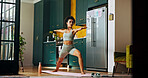 Woman, yoga and warrior pose in home with laptop for online course, breathing and wellness in kitchen. Girl, person and start routine with zen, chakra and mindfulness with balance in morning at house