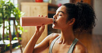 Home, woman and fitness with water for health, hydration or nutrition for wellness for exercise. House, female person and workout break with liquid bottle for h2o drink, detox or thirsty in apartment