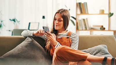 Buy stock photo Cellphone, relax and woman on sofa in home with networking, communication or contact on mobile app. Happy, phone and female person texting on social media for online conversation in living room.