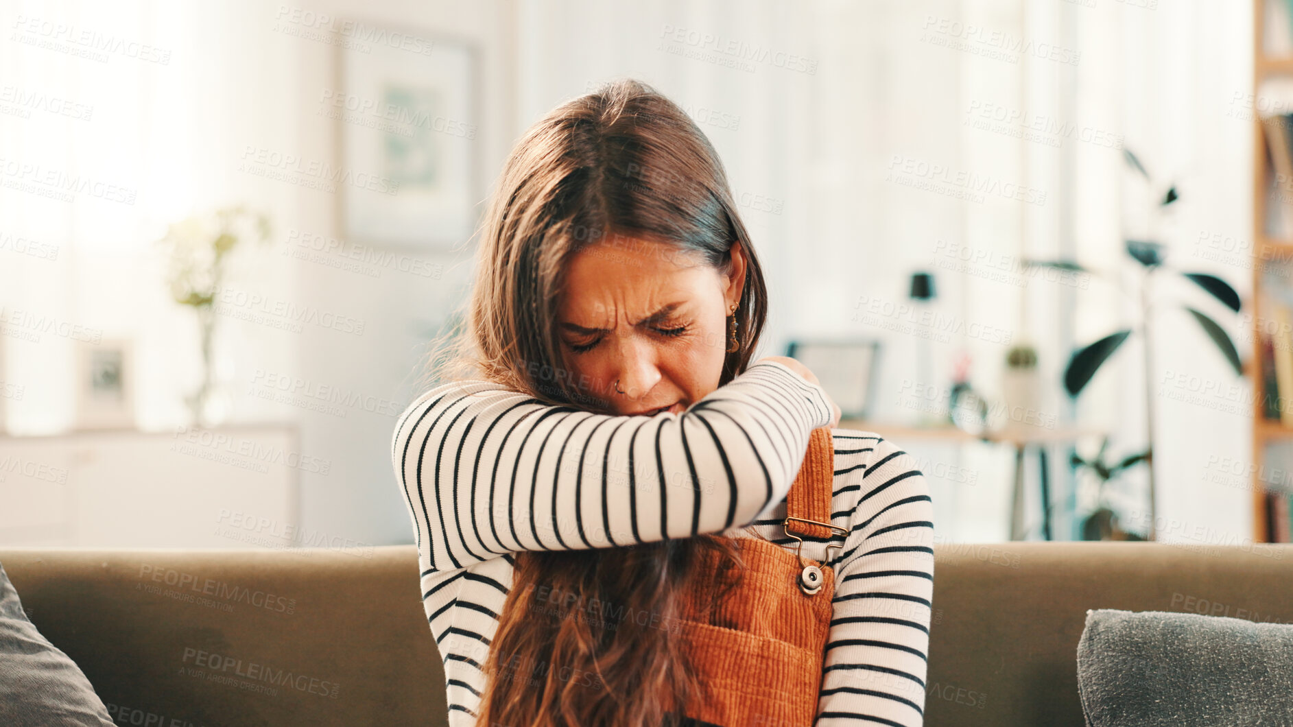 Buy stock photo Home, sneeze and woman on sofa, cough and disease with cold, pneumonia and bronchitis in living room. Apartment, person or girl with elbow, sick or allergies with chest pain, sinus or asthma symptoms