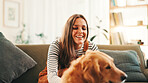 Playing, relax or happy woman in home with dog, support or companion in lounge with care or love. Animal adoption, laughing or girl in apartment with golden retriever, best friend or pet for bonding