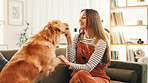 Love, training or happy woman in home with dog, support or companion on sofa with care or love. Animal adoption, obedience or person in apartment with golden retriever, best friend or pet for bonding