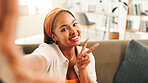 Peace sign, selfie and portrait of woman in house for relax, calm and break on weekend for social media. Happy, sofa and female person with photography for profile picture in living room at home.