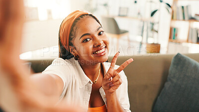 Buy stock photo Peace sign, selfie and portrait of woman in house for relax, calm and break on weekend for social media. Happy, sofa and female person with photography for profile picture in living room at home.