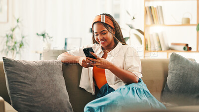 Buy stock photo Smile, online and woman with smartphone on sofa for social media, reading forum or ebook. African person, mobile and relax in home with chat app for communication, text notification or download game
