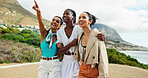 Women, friends and point on vacation at beach, promenade or happy with hug, sightseeing and location. People, girl and group with smile, outdoor and search for direction on holiday by ocean in summer