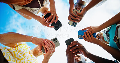 Buy stock photo Below, outdoor and people with smartphone, hands or circle with nature, connection or social media. Low angle, group or friends with blue sky, cellphone or tech with network, message or communication