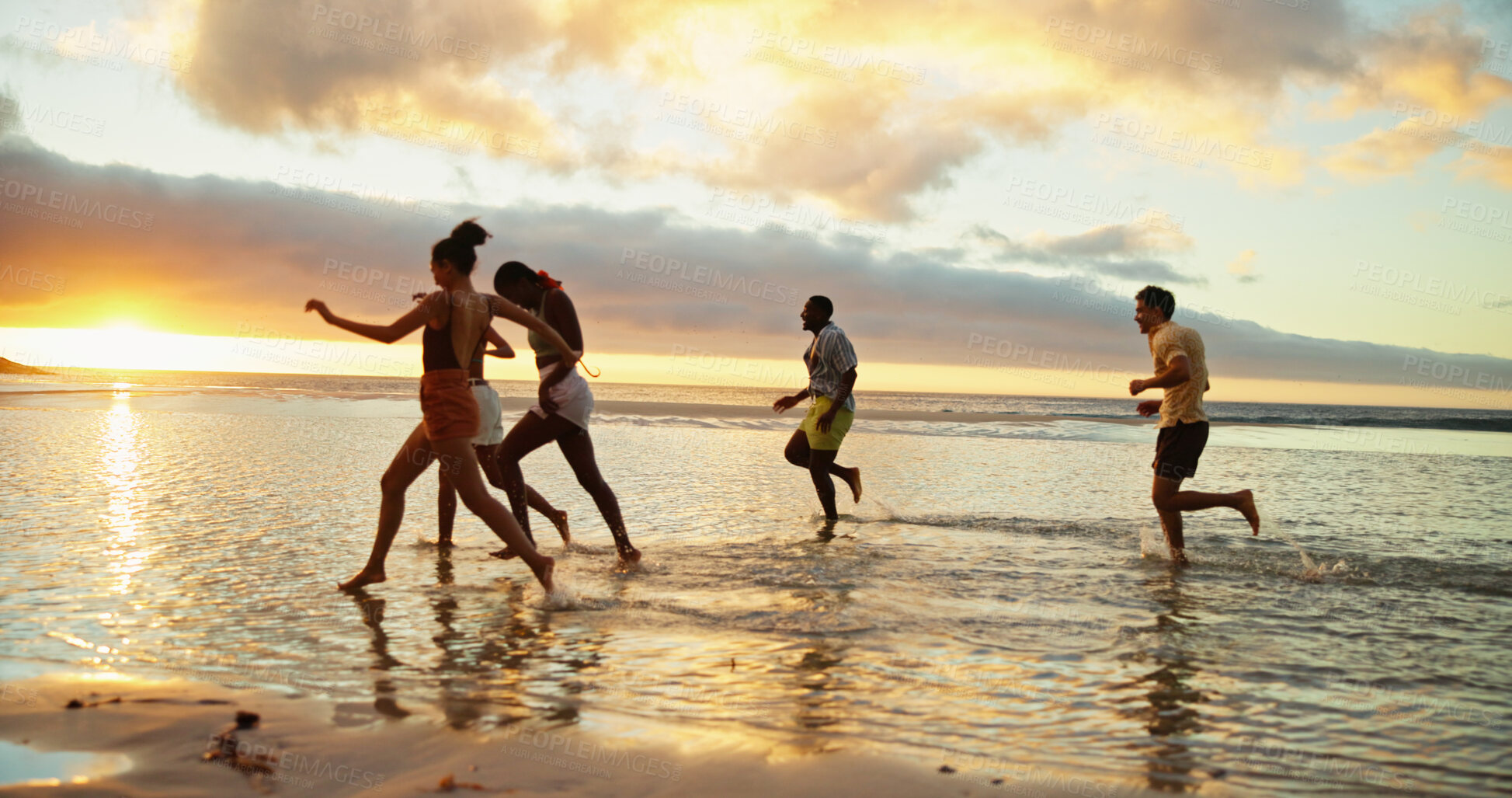 Buy stock photo Sunset, running and friends at beach by water for holiday, vacation and summer trip on tropical island. Group, ocean and people race at sea with energy for freedom, travel and excited for adventure