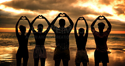 Buy stock photo Friends, heart hands and people by sunset, beach and back with connection for love with care by sea. Group, together and community for symbol, sign and support with kindness on vacation by ocean
