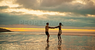 Buy stock photo Couple, holding hands and spin for fun on beach for travel date, energy and sunset of summer holiday. People, playful and romantic for vacation trip, tropical island and partner commitment of getaway