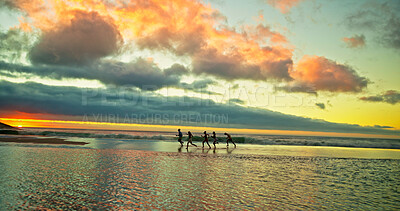 Buy stock photo Sunset, people running and friends at sea for holiday, vacation and summer trip on island. Group, ocean water and race by beach together for freedom, travel or energy for adventure at dusk with space