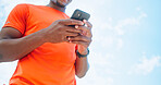 Fitness, phone and sky with hands of man outdoor for exercise, training or workout from below. App, sports and tracking with athlete or runner on break from cardio challenge for performance update