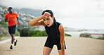 Fatigue, running and woman in street, fitness and breathing with training, exercise and challenge. Sweating, runner and athlete with workout, outdoor and practice with health, wellness and tired