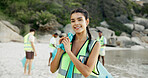 Plastic bag, portrait and recycling with woman on beach for community service or conservation. Charity, earth day and smile of volunteer coast for activism, collecting waste or sustainability