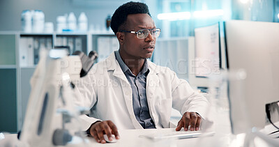 Buy stock photo Computer, black man and scientist typing in lab for medical research, discovery or innovation, Tech, science and African male biologist with pharmaceutical report for futuristic genetic development.
