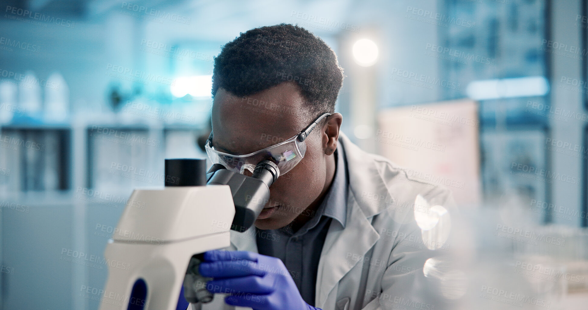 Buy stock photo Microscope, black man and scientist in laboratory with goggles for medical research, discovery or project. Biotechnology, science and African biologist with equipment for DNA review for innovation.
