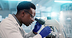 Microscope, black man and scientist in lab for research, discovery or project on medical organisms. Biotechnology, goggles and African biologist with equipment for DNA review for innovation.