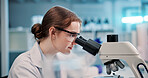 Microscope, woman and scientist in laboratory for research, discovery or project on medical organisms. Biotechnology, goggles and female biologist with equipment for DNA review for innovation.