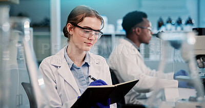 Buy stock photo Lab, scientist and woman with medical research, writing and info for reminder, serious or pharmaceutical. Clinic, colleagues and person with glasses for protection, science or notebook for healthcare