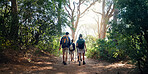 Hiking, back and people in nature walking for adventure, trekking and travel on holiday. Mountain, friends and men and women for hobby on trail for wellness, fresh air or exercise to explore outdoors