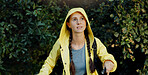Trekking, walking and woman explore forest with flashlight, travel adventure and holiday expedition. Mission, person and hiking with backpack in woods for sightseeing, raincoat and winter journey