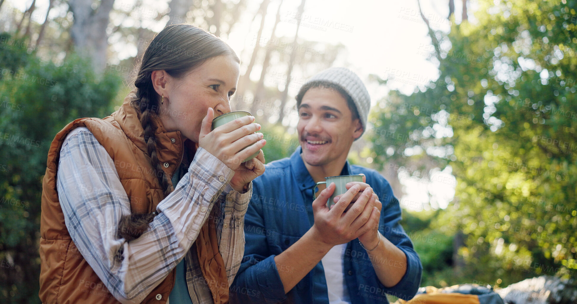 Buy stock photo Outdoor, camping and couple with coffee, drinking and bonding with warm beverage in nature and adventure. Hiking, travel and people with hot tea for cold weather, traveller and tourists on vacation