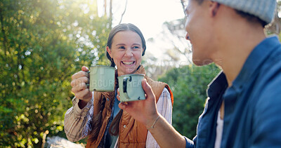 Buy stock photo Outdoor, camping and couple with coffee, cheers and bonding with warm beverage in nature or adventure. Hiking, travel and people with hot tea for cold weather, toast or tourists with love in vacation