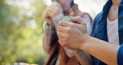 Buy stock photo Outdoor, camping and couple with coffee, hands and bonding with warm beverage in nature and adventure. Closeup, travel and people with hot tea for cold weather, drinking and tourists on vacation