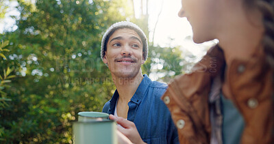 Buy stock photo Outdoor, camping and couple with coffee, smile and bonding with warm beverage in nature and adventure. Forest, travel and people with hot tea for cold weather, traveller and tourists on vacation