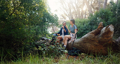 Buy stock photo Happy women, friends or eating with break at forest for hiking, journey or adventure together in nature. Female people, rest or laughing with snack or food for trekking, trip or outdoor exploration