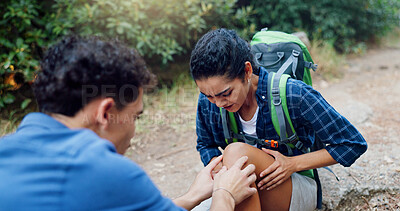 Buy stock photo People, hiker and knee pain with injury for accident, fall or emergency on trekking trail or path in nature. Man, woman or friends with ache, joint inflammation or sore leg for medical assist or aid