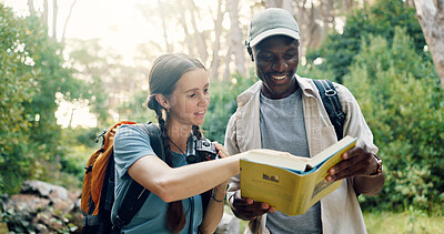 Buy stock photo Travel, couple and book for birdwatching in forest, info and knowledge of bird species in nature. Interracial, people and binoculars for sightseeing, hiking and trekking with animal search in woods