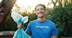Volunteer, man and portrait with plastic bag at park for environment cleanup, community service and recycling. Sustainable NGO, person and happy in nature for social responsibility and green project