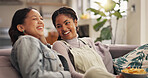 Bonding, laughing and woman best friends on sofa in living room of home together for reunion or visit. Funny, happy and relax with people in apartment for gossip, relationship or social on weekend