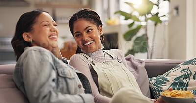 Buy stock photo Bonding, laughing and woman best friends on sofa in living room of home together for reunion or visit. Funny, happy and relax with people in apartment for gossip, relationship or social on weekend