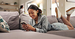 Home, relax and woman on sofa, smartphone and typing with smile, social media and texting. Apartment, mobile user or happy person on couch, cellphone or digital app for message to contact or internet