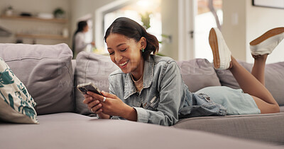 Buy stock photo Home, relax and woman on sofa, smartphone and typing with smile, social media and texting. Apartment, mobile user or happy person on couch, cellphone or digital app for message to contact or internet