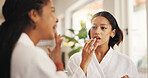Beauty, lip gloss and self care with friends in home living room together for me time or spa day. Apply, relax and wellness with women in apartment for cosmetics, dermatology or transformation
