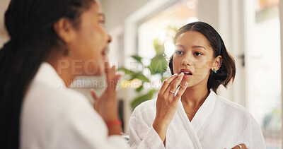 Buy stock photo Beauty, lip gloss and self care with friends in home living room together for me time or spa day. Apply, relax and wellness with women in apartment for cosmetics, dermatology or transformation