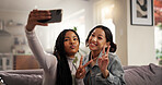 Happy women, friends and peace sign with selfie on sofa for picture, photography or memory at home. Female people, user or smile with emoji for capture moment, social media or post on couch at house