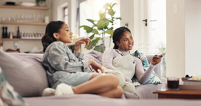 Buy stock photo Watching tv, women and friends with phone, relax and bonding with reality show, smile and entertainment. Home, girls and people with mobile app to change channel, together and streaming of movies