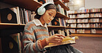 Woman, student and headphones at library with reading book on floor, study and song with scholarship at college. Girl, education and listening to music, streaming and prepare for test at university
